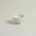 White ceramic bowl on a beige background